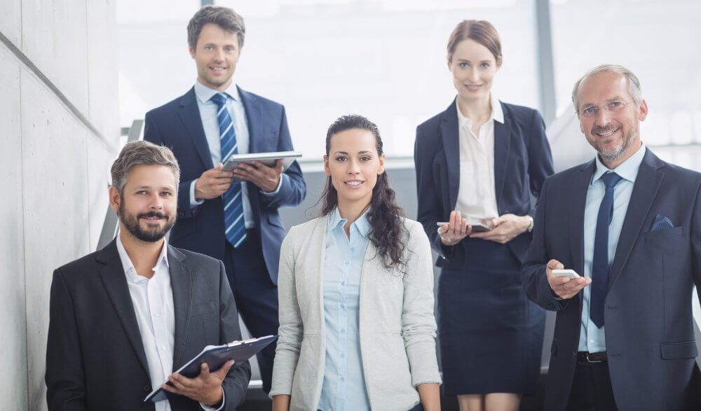 group confident businesspeople office e1682336086289